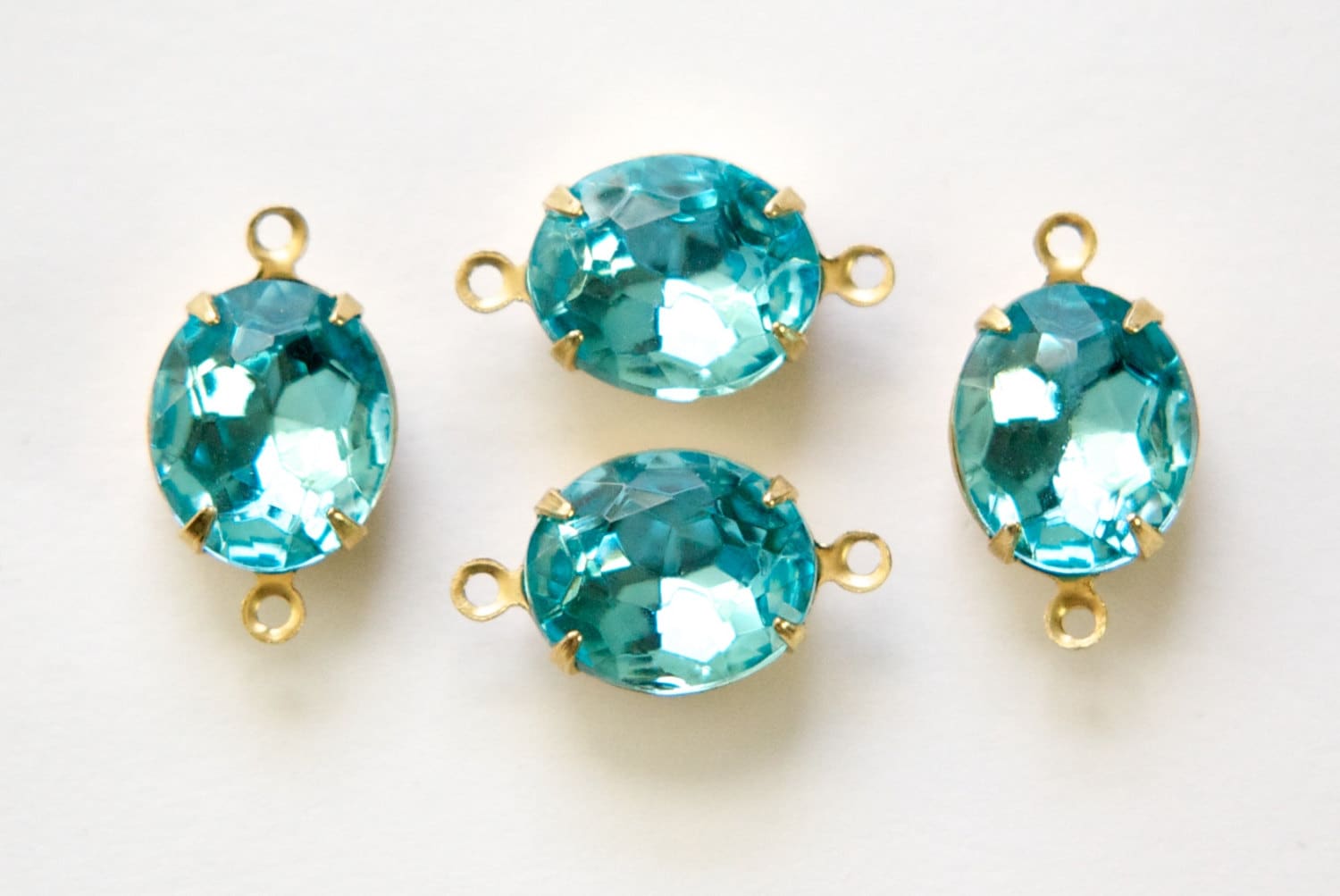 Aqua Blue Faceted Oval Glass Stones in 2 Loop Brass Setting ovl011L2